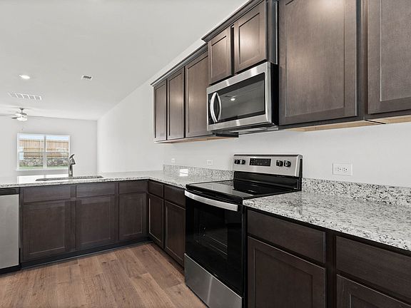 The kitchen of the Driftwood has beautiful wood cabinetry.