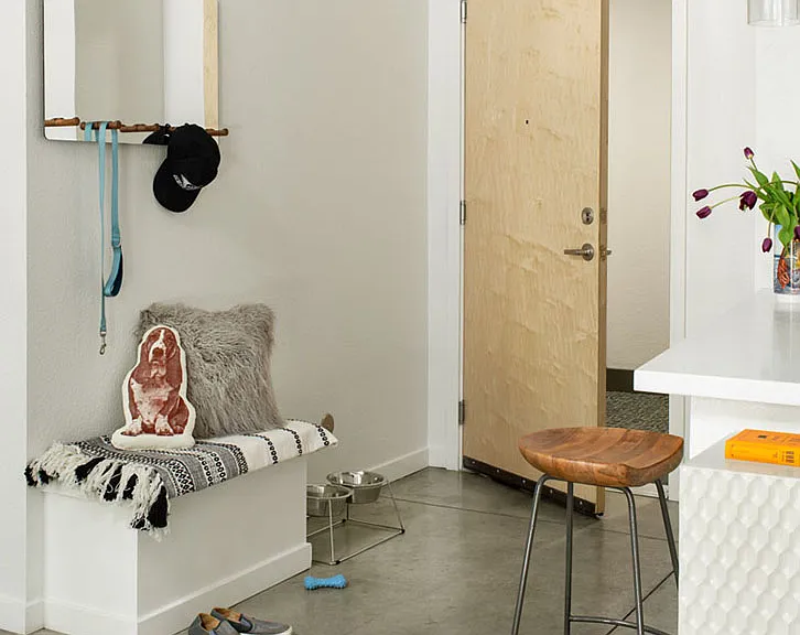 Apartment entry with concrete flooring.