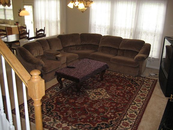 Large Open Family Room Features a Gas Fireplace and has a view of the backyard