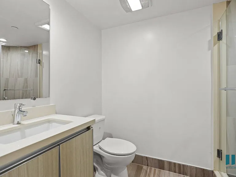 Bedroom with Stand-Up Shower and Vanity Cabinet Storage