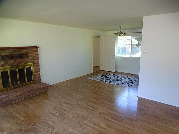 Living room and dining room with oak floors.