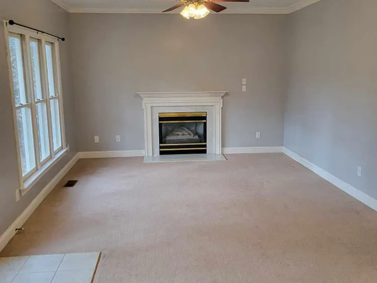 Looking from kitchen nook into Den area with gas fire place.