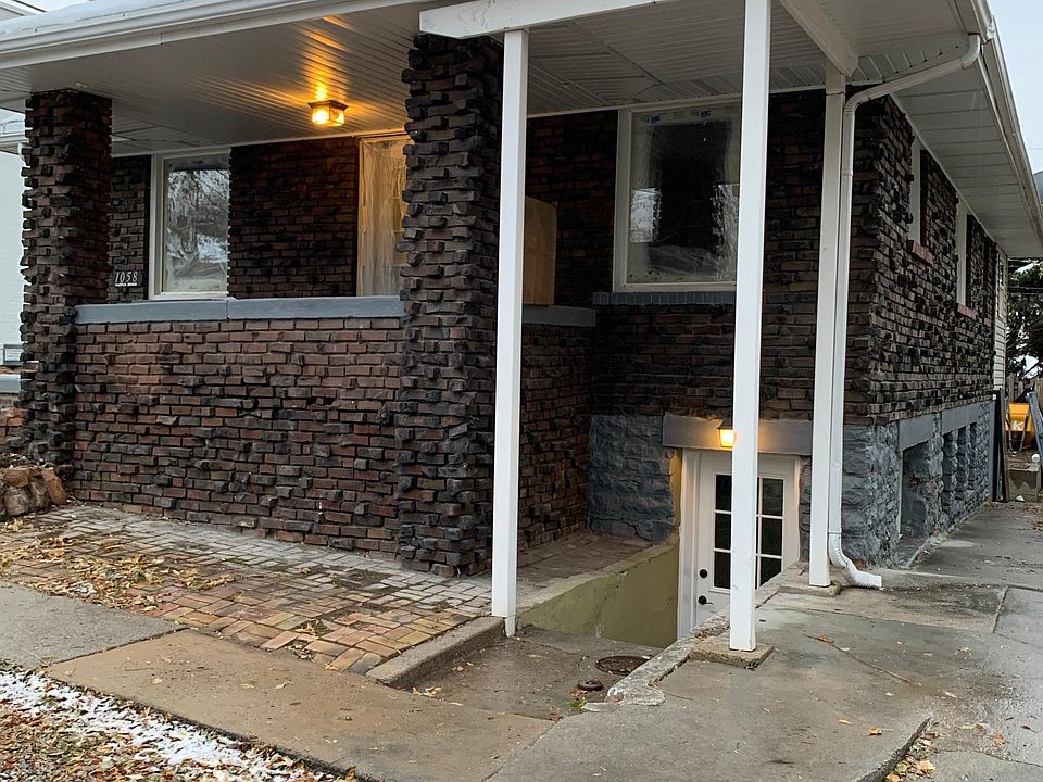 View of basement front door and front of house/ ground level windows on West side are basement living room