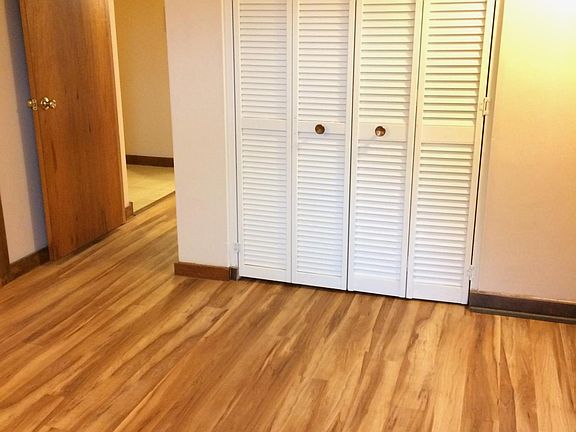 Bedroom 1 facing toward living room & bedroom entry. View of closet. The door you see on the left leads into the living room. Just outside the door is the tile floor that leads to a hallway to the bathroom.