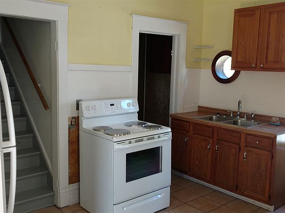 Kitchen with view of pantry door and stairs going to the sec