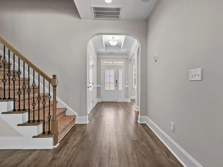 Living room to front door and stair case