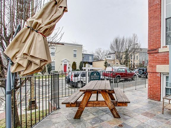 Outdoor patio with picnic table. Additional grass area not pictured.