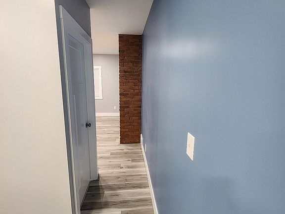 hallway off of living room into kitchen with basement door access