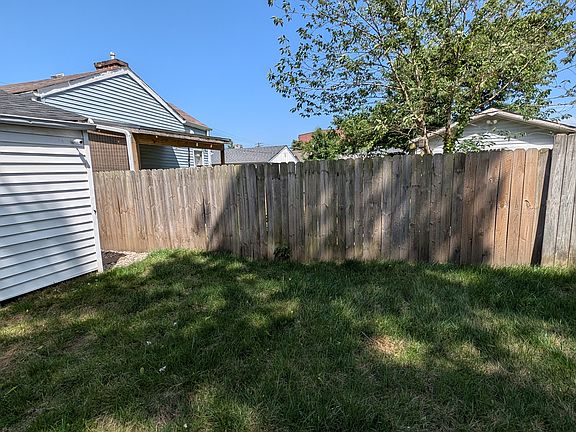View of the quiet, enclosed backyard with easy access to the home and a perfect spot for outdoor activities or gatherings.