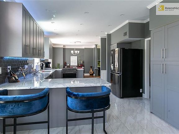 Plenty of lighting in this gorgeous kitchen that opens right up into the dining and living rooms