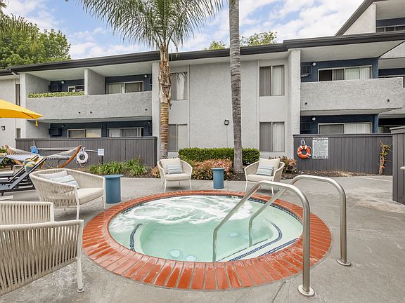 Relaxation oasis: Dive into luxury at Cornerstone Apartments, where every dip in our updated pool and hot tub is a retreat under the palms.
