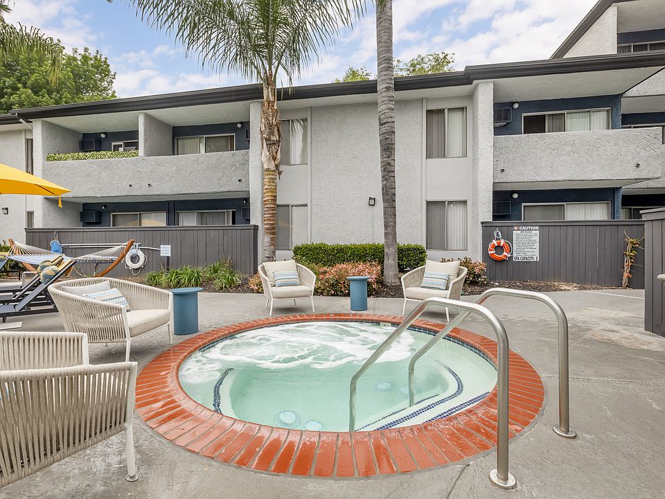 Relaxation oasis: Dive into luxury at Cornerstone Apartments, where every dip in our updated pool and hot tub is a retreat under the palms.