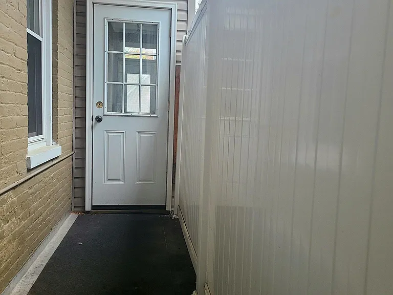 Grill area off enclosed back porch; great for bike storage
