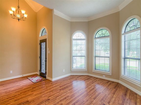 Rounded wall of windows in the formal dining room just off the entry way. Crown molding and molding 