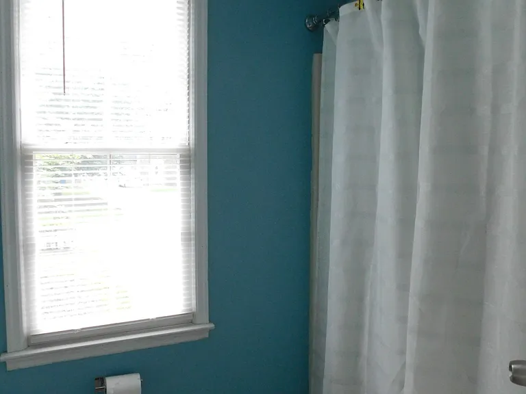 Second full bathroom off the hallway in bright aqua and white colors.
