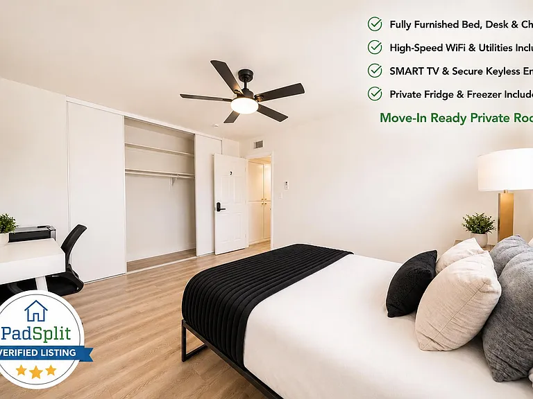 Furnished bedroom with desk area, ceiling fan, and sliding-door closet for convenient storage.