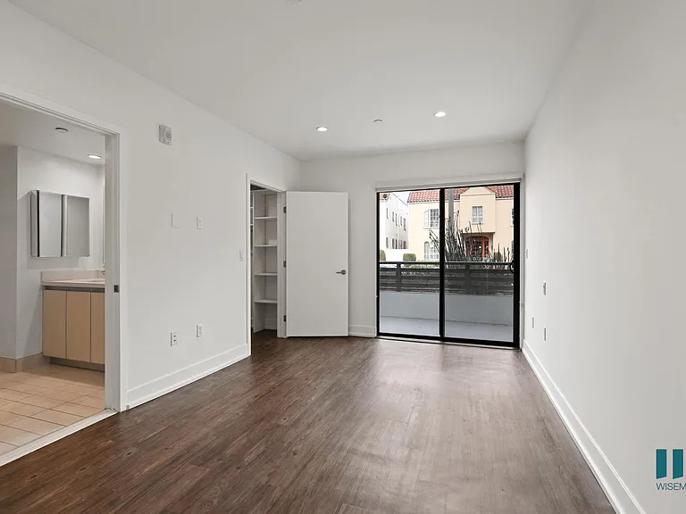 Bedroom with Walk-In Closet, Bathroom, and Balcony Access