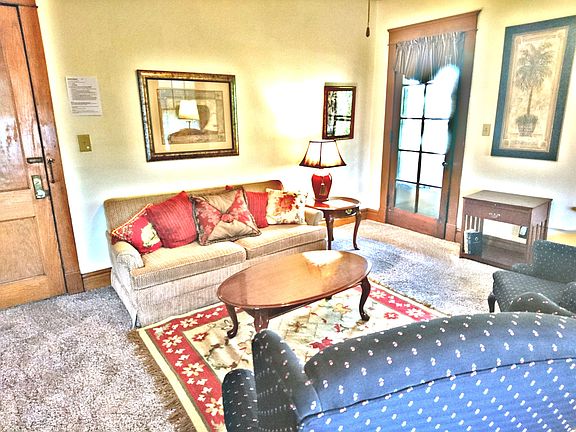 Living room looking at front door and porch door