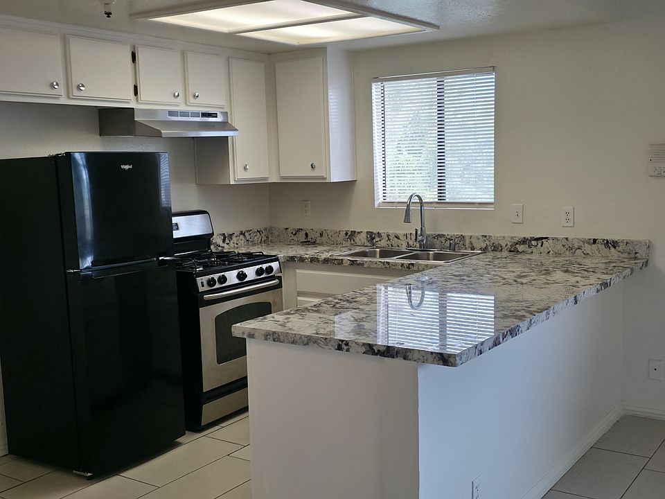 Nice area view from kitchen window with ample cabinets, and spacious dining room.