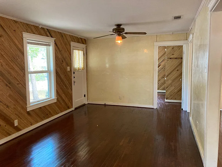 Living room with front door and entry into bedroom #1