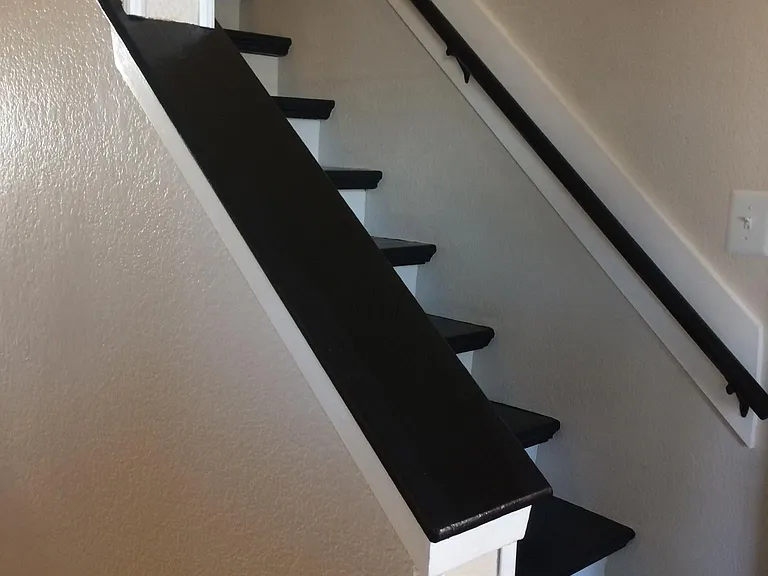 Wood ledge at staircase with wood steps.