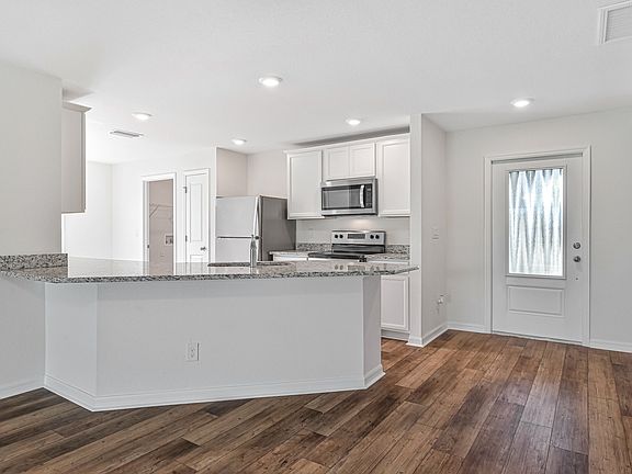 Kitchen looks out into the family room
