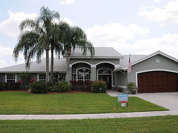 Front yard nicely landscaped.
						:
						Widened drive and walkway, metal roof, faux wood garage and front doors