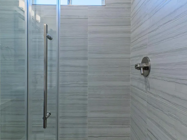 High pressure delta shower head and custom glass frameless shower doors.