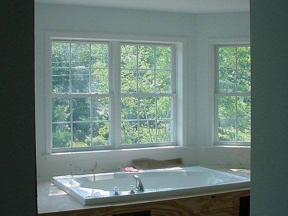 Master bath jacuzzi surrounded in windows and tile!