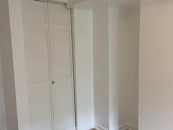 Opposite side of the front bedroom. Most folks tuck a bookcase in that niche. There's room to the left of the closet for a dresser or desk.