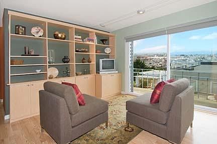 Living room - open floor layout, large views of downtown and the bay. Walls have been repainted to a neutral color.
