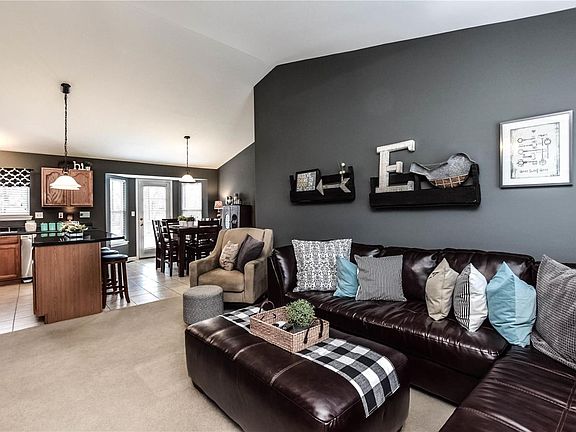 Vaulted great room is open to kitchen and breakfast room with bay