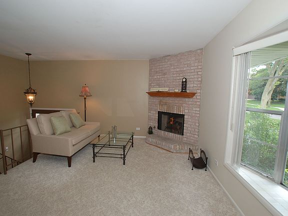 Cozy living room with fireplace and big bright window!