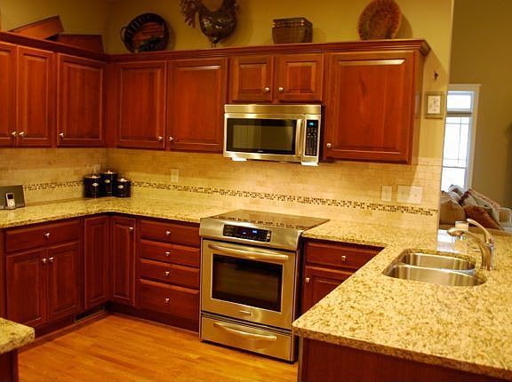 Kitchen with granite and tile backsplash