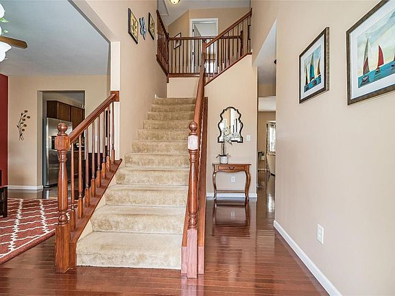 Two story entry foyer with wood flooring.