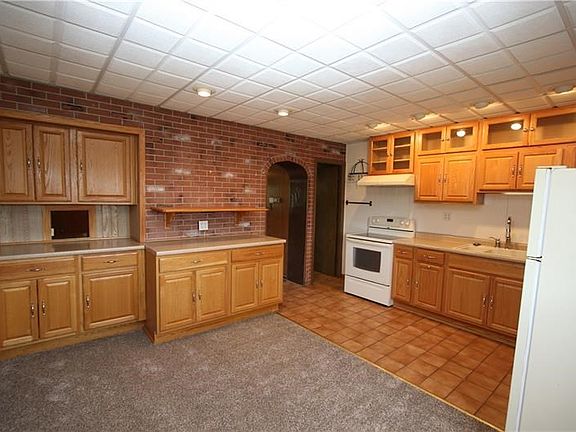Open 14x18 Kitchen & Dining Room Updated appx 5yrs accented w/ Beautiful Brick Wall, Plenty of Newer Wood Cabinets, Ceramic Tile