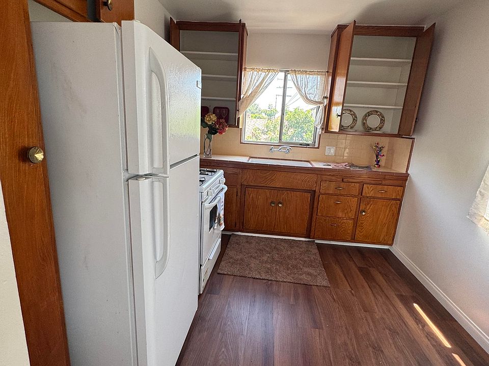 Nice size kitchen with refrigerator, stove, lots of wood storage cabinets, new plank floor, and 2 windows.