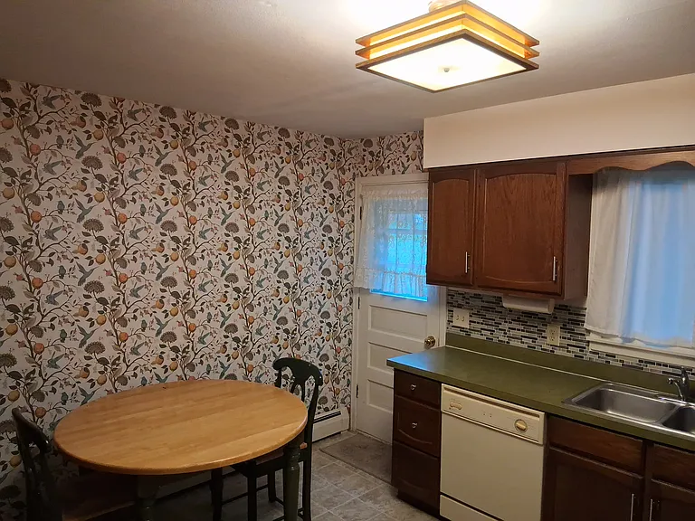 Eat-in kitchen with door to patio and large, beautiful green space
