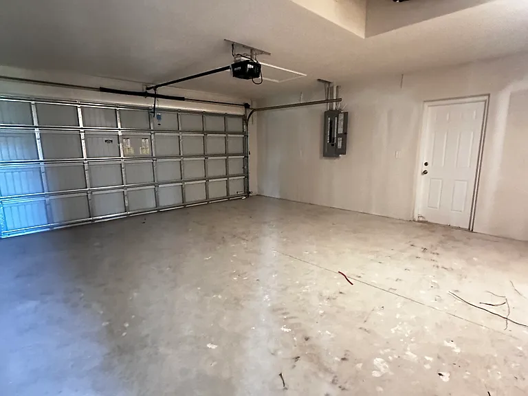 Two car garage with side door giving you access to the yard.