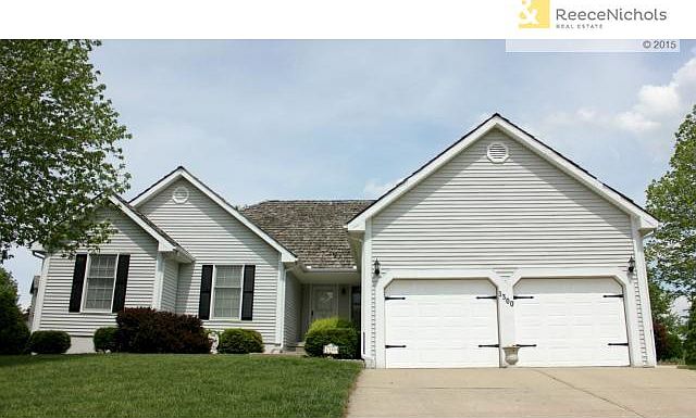 Gorgeous updated front of house with newly painted shutters and garage door hardware