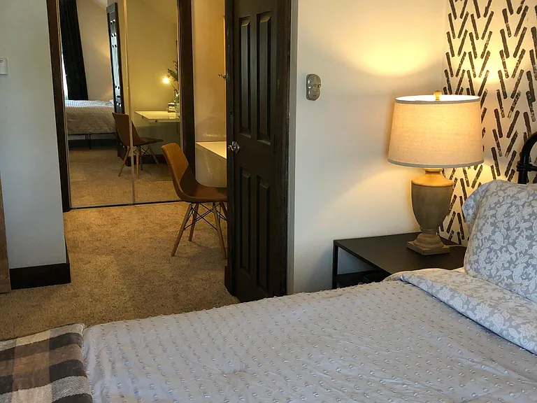 Upstairs queen bedroom #2. Also has a private bathroom with a stall shower, a closet and a desk.