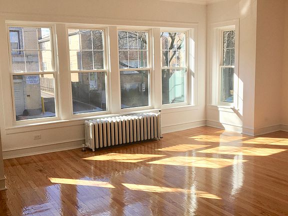 Huge living room facing the street with gorgeous afternoon s