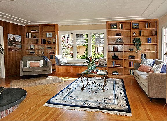 Captivating living room with wood stove and hearth, & glowing hardwood floors