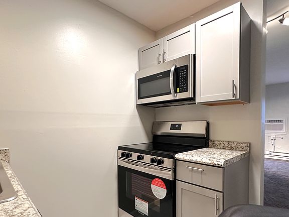 Brand new stainless:
 smooth top range & vented microwave