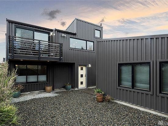 view of front of townhouse and window side of detached garage