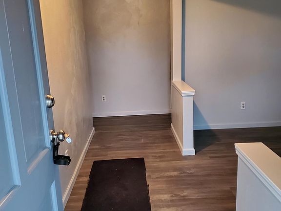 Entry way with a living room to the right of the entrance.