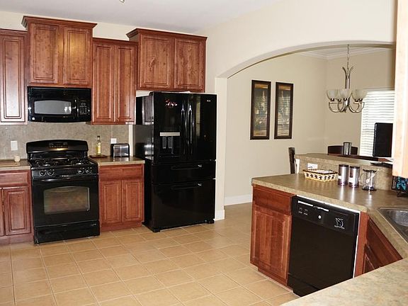 spacious kitchen with lots of cabinets and counters. Built-in microwave, gas stove, dishwasher.  Porcelain tile floor in kitchen and dining
