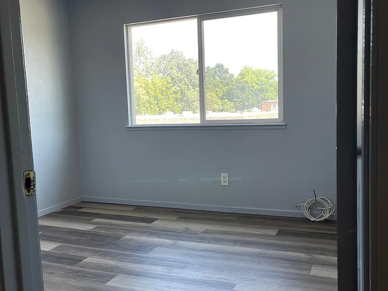 Bright room facing front of property, all new flooring and paint