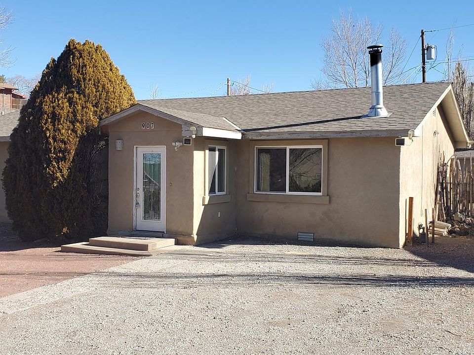 Front of house, side access to backyard. Storage shed pictured in back.