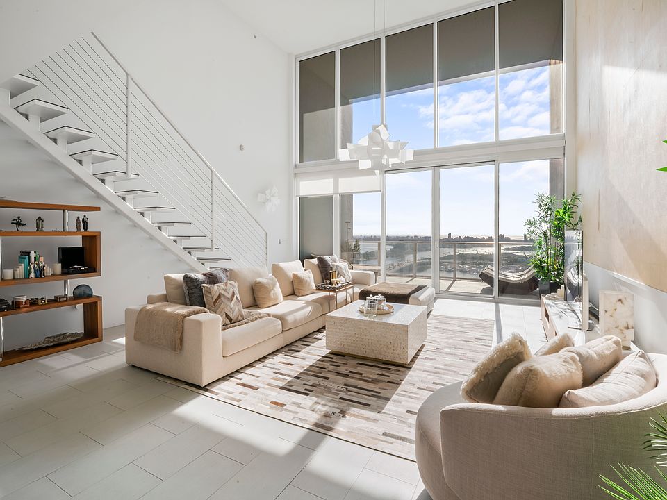 Electric white sheer curtain was installed for this gorgeous 20' ceiling/windows.